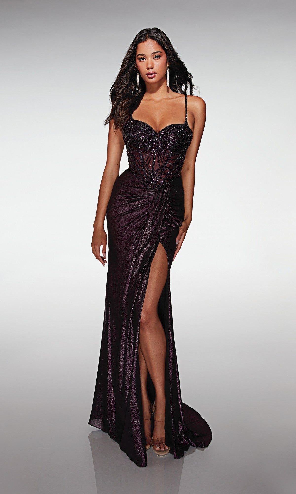 A woman poses against a light background in the Alyce 62143 long formal dress in Black Plum, featuring a strapless, embellished corset bodice with sweetheart neckline, high slit, and beaded details.